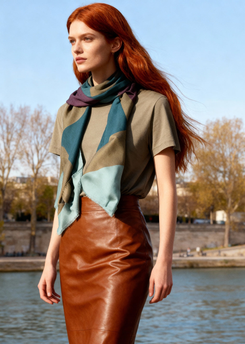 model wears a green brown geometrc printed scarf wlking in Paris